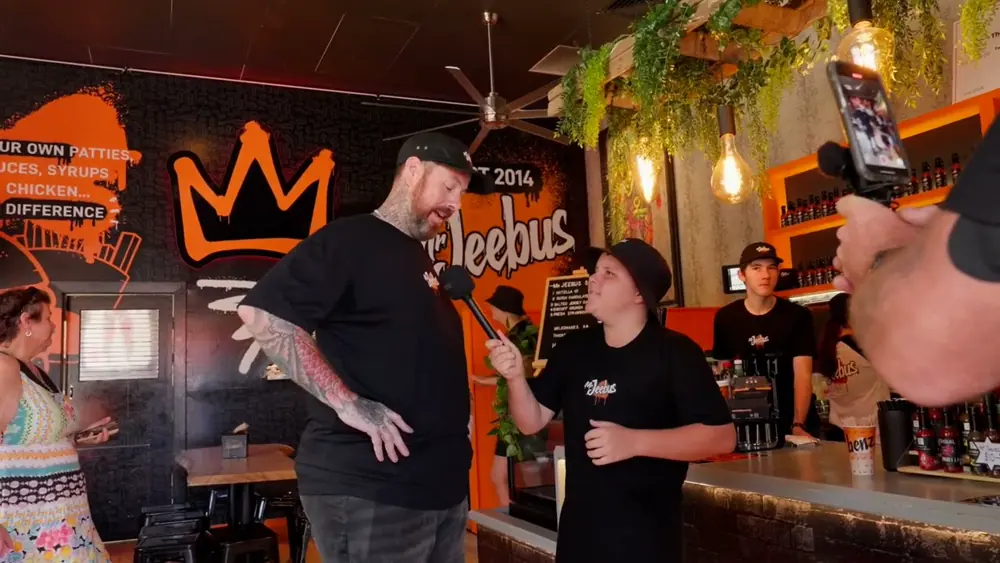 Inside a Mr Jeebus shop, with the crown mural on the wall.